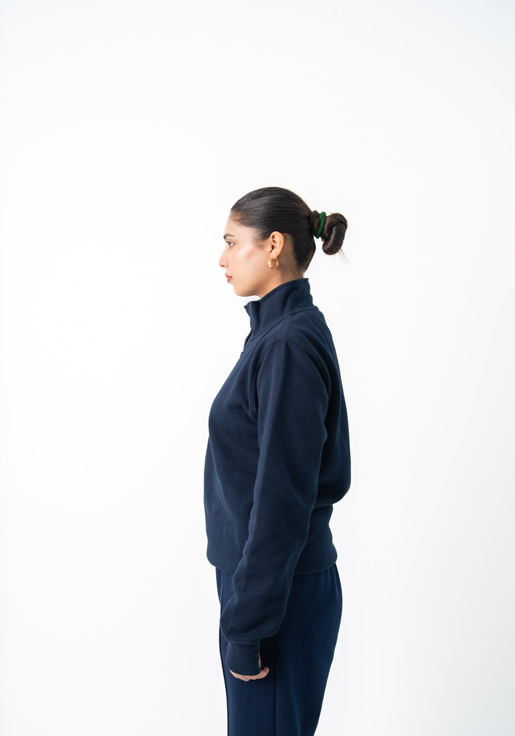 Person wearing a navy blue outfit on a white background