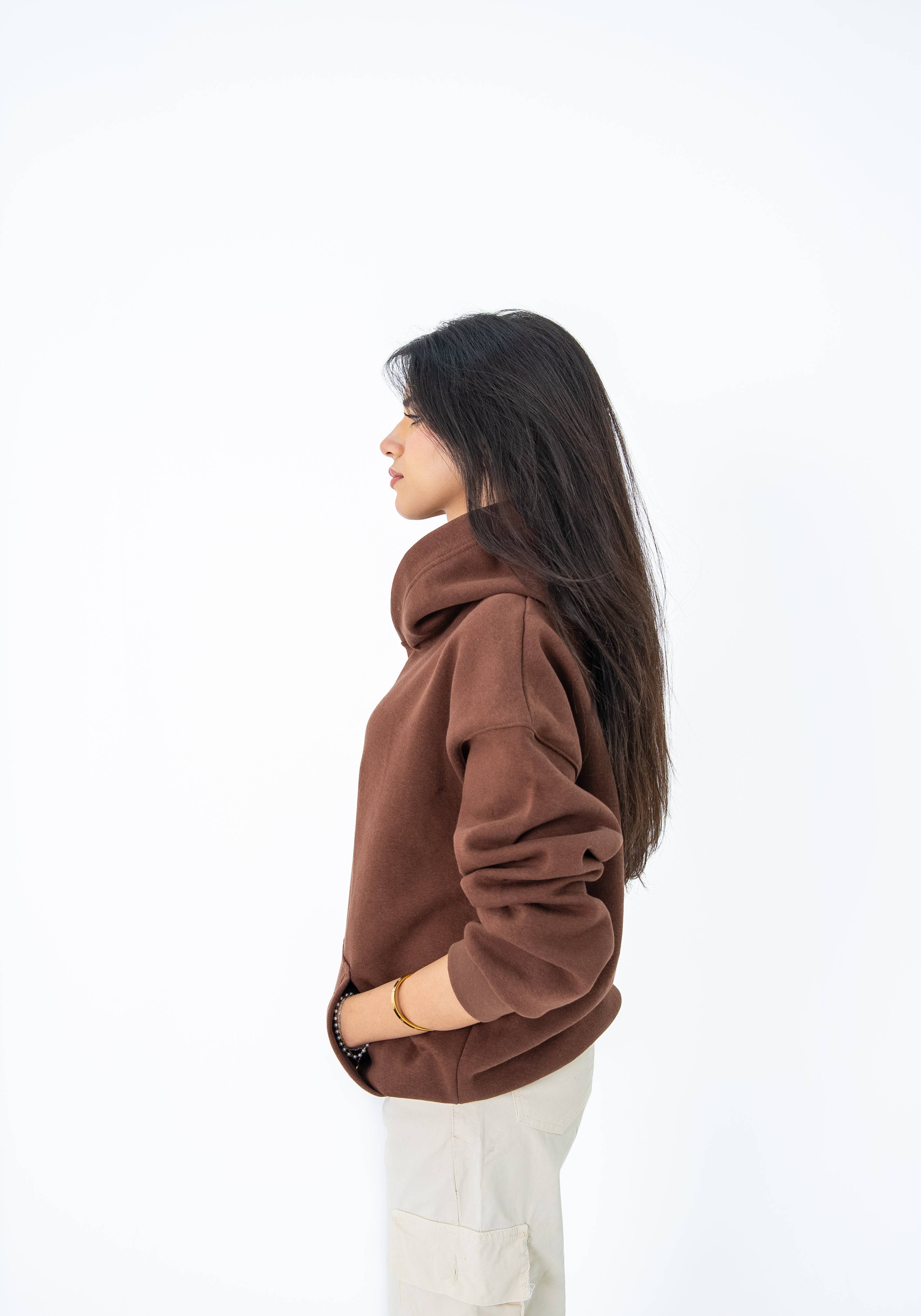 Woman wearing a brown sweater on a white background