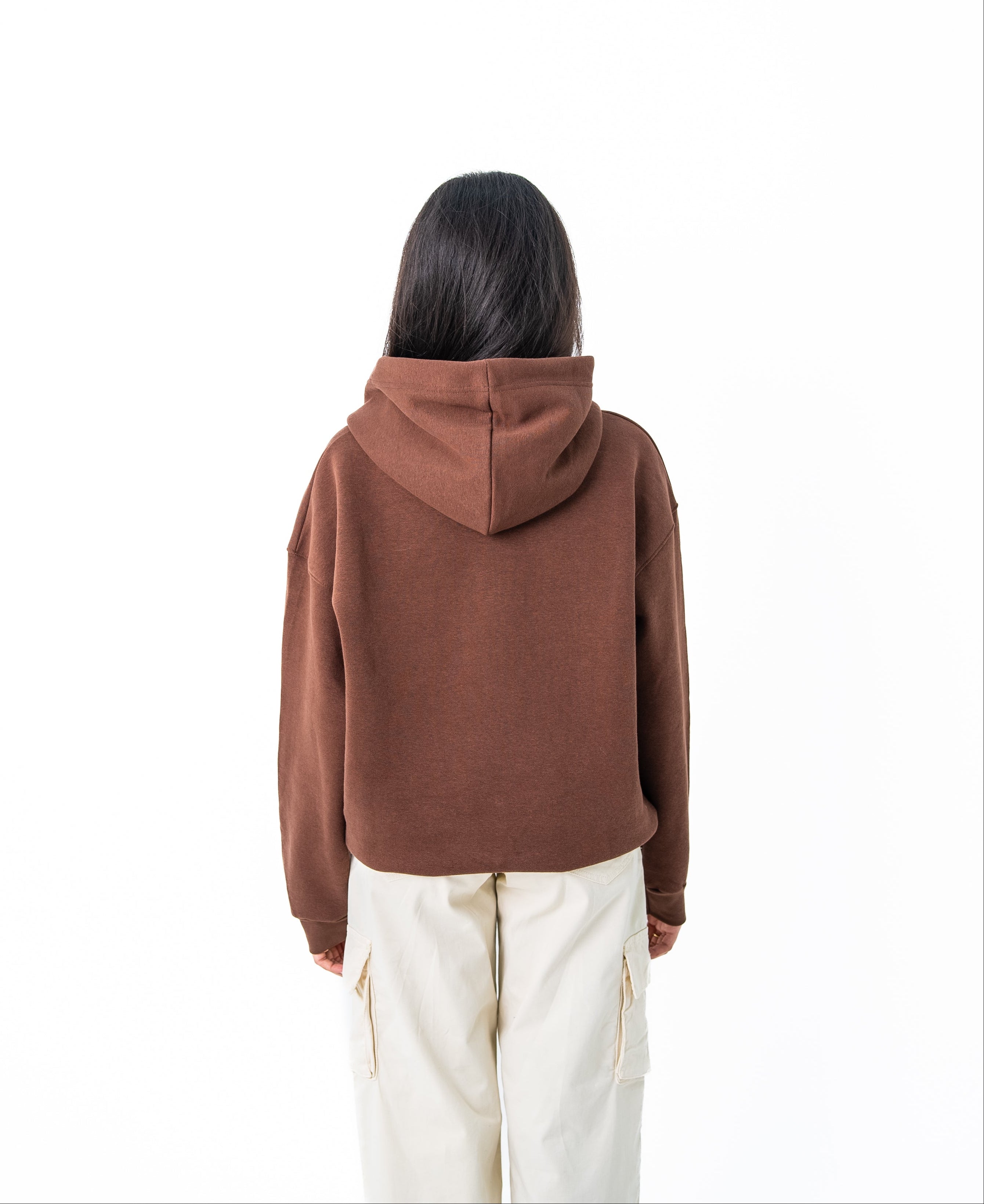 Person wearing a brown hoodie on a white background