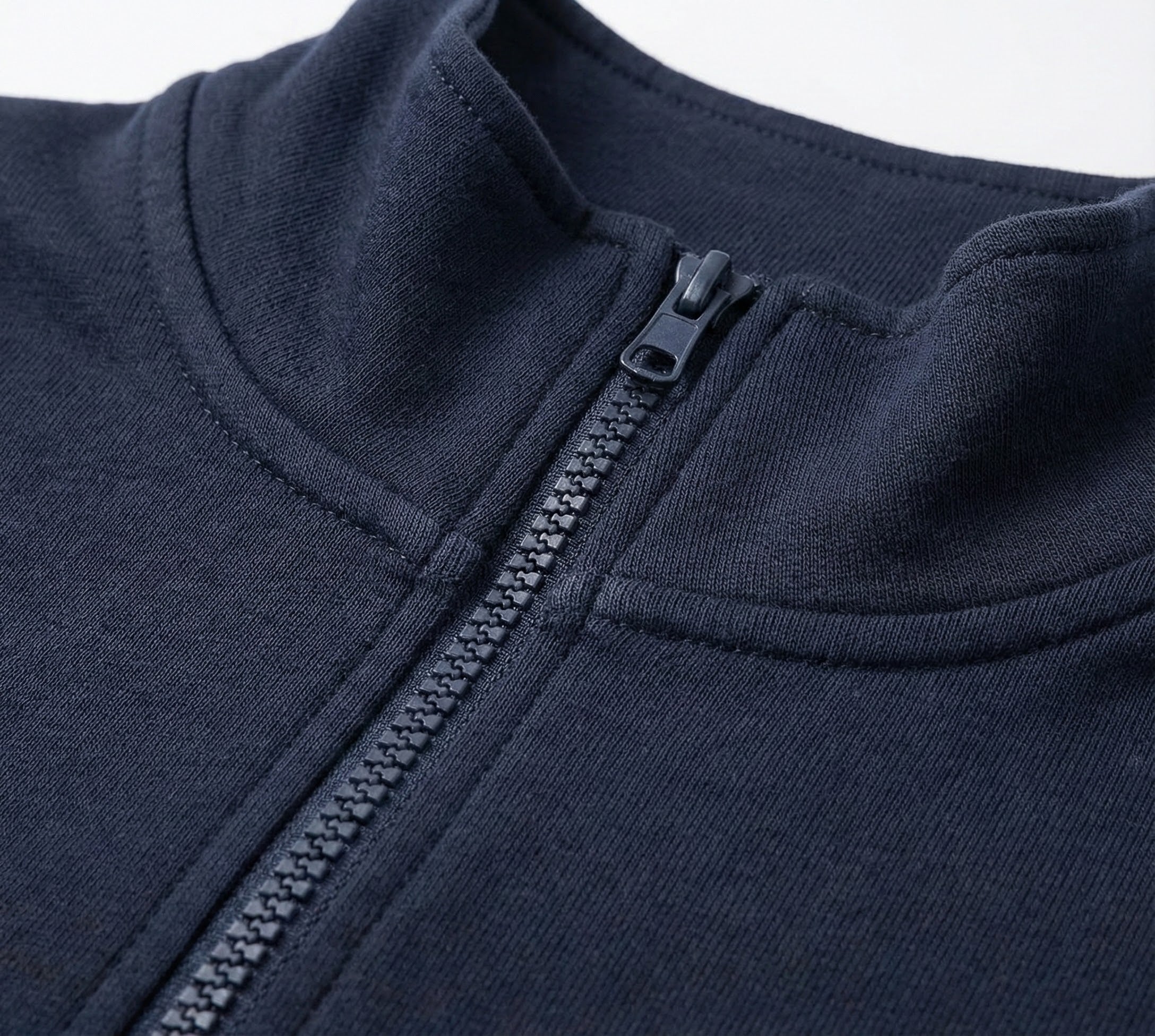 Close-up of a navy blue jacket with a zipper